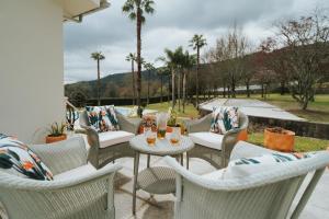 a patio with chairs and a table with drinks on it at Quinta Clara in Vila Verde