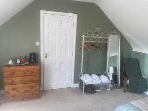 a bedroom with a closet with a mirror and a dresser at Shanboley Cottage in Ballinasloe