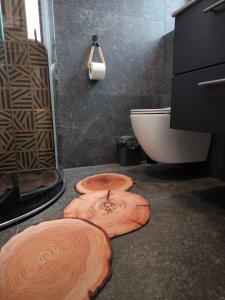 a bathroom with three wooden mats on the floor at Ferienwohnung Kampić Turmblick in Rottweil +43 photos