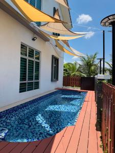 a swimming pool in the backyard of a house at A home with private pool, KebunStorey in Tangga Batu