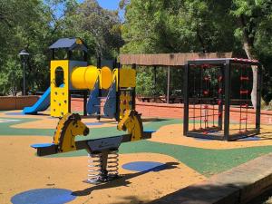 a playground in a park with a play equipment at Lisboa Bungalows in Lisbon