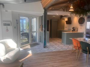 a kitchen and living room with a table and chairs at Lily's Place in Wexford