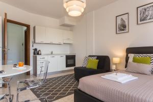 a living room with a bed and a kitchen at Residenze Su Planu in Cagliari