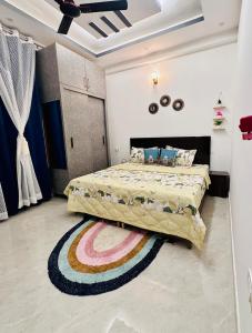 a bedroom with a large bed with a rug at Warm Nest in Dehradun