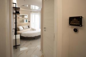 a bedroom with a bed and a room with a window at Elysium suites & Spa in Barletta