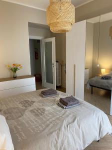 a bedroom with a bed with two towels on it at A Casa di Katia in Collegno