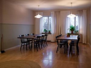 a dining room with wooden tables and chairs at Marinans Guesthouse in Nävekvarn