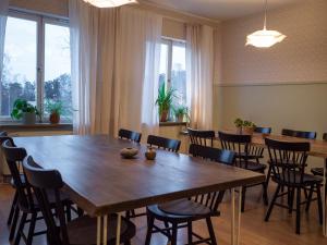 a conference room with a large wooden table and chairs at Marinans Guesthouse in Nävekvarn +51 photos