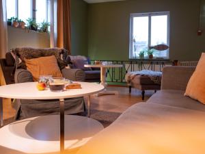 a living room with couches and a table with food on it at Marinans Guesthouse in Nävekvarn