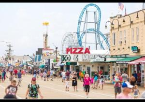 a crowd of people walking around an amusement park at Watson's Regency Suites in Ocean City