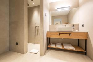 a bathroom with a sink and a shower at Etra Suites & Apartments in Riva del Garda +56 photos