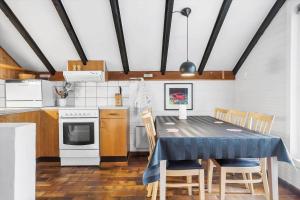 a kitchen with a table and chairs in a room at 692-Thisted-Mose-Bollevej-6 in Thisted +11 photos