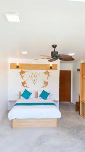 a bedroom with a bed with a ceiling fan at Island Break in Fulidhoo