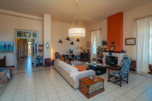 a living room with a couch and a table at Captain's Mansion Exampela in Apollonia