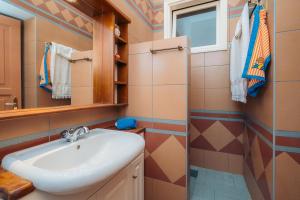 a bathroom with a sink and a shower at Captain's Mansion Exampela in Apollonia +46 photos