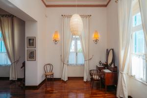 a living room with a desk and a window at Captain's Mansion Exampela in Apollonia