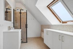 a bathroom with a sink and a shower with a skylight at 1356-Thisted-Nordsovej-106 in Thisted +19 photos
