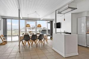 a kitchen and dining room with a table and chairs at 1356-Thisted-Nordsovej-106 in Thisted