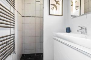 a white bathroom with a sink and a mirror at 1375-Thisted-Nordsovej-15 in Nørre Vorupør +18 photos