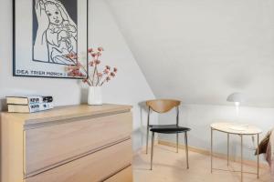 a bedroom with a dresser and a table and a chair at 1375-Thisted-Nordsovej-15 in Nørre Vorupør