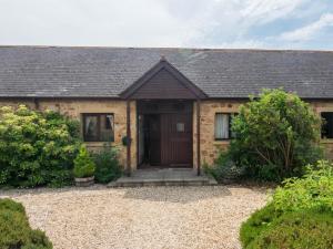 a brick house with a brown door at 2 Bed in Bridport oc-dc162 in Chideock