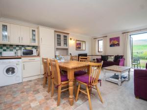 a kitchen and living room with a table and chairs at 2 Bed in Bridport oc-dc162 in Chideock