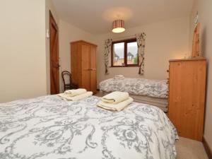 a bedroom with two beds with towels on them at 2 Bed in Bridport oc-dc162 in Chideock