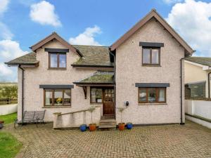 a white brick house with a patio at 3 Bed in Penrith oc-90990 in Pooley Bridge