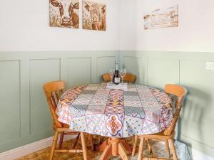 a dining room table with a quilt on it at Middle Cottage in Thirsk
