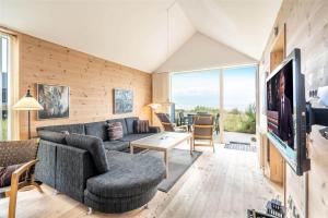 a living room with a couch and a tv at 711-Hvide-Sande-Slusen-11 in Hvide Sande