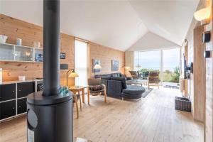 a living room with a wood stove in a house at 711-Hvide-Sande-Slusen-11 in Hvide Sande