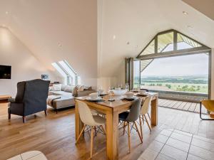 a living room with a table and chairs and a couch at 2 Bed in Forfar oc-92621 in Aberlemno