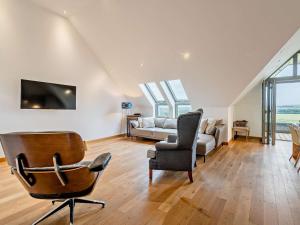 a living room with a couch and a chair at 2 Bed in Forfar oc-92621 in Aberlemno