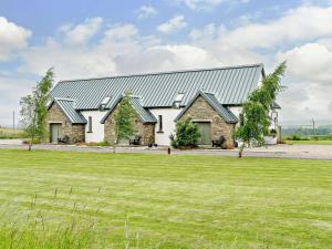 a home with a metal roof and a grass field at 2 Bed in Forfar oc-92621 in Aberlemno
