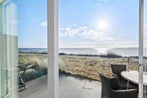 a view of the ocean from a room with a table and chairs at 749-Hvide-Sande-Slusen-49 in Hvide Sande