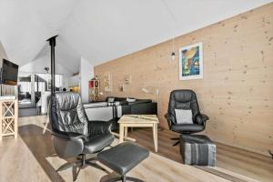 a living room with two chairs and a table at 749-Hvide-Sande-Slusen-49 in Hvide Sande