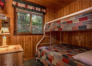 a bedroom with a bed in a wooden cabin at Bayside - Bouchard Shores Resort in Minocqua