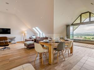 a living room with a wooden table and chairs at 2 Bed in Forfar oc-92623 in Aberlemno