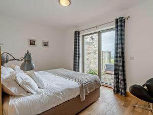 a bedroom with a bed and a large window at 2 Bed in Forfar oc-92623 in Aberlemno +22 photos