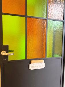 a door with a stained glass window with a sign on it at Casa Josefina Hotel Boutique in Olavarría