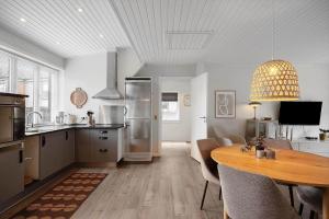 a kitchen with a table and a dining room at 890-Hvide-Sande-Bredgade-3-B-1 in Hvide Sande
