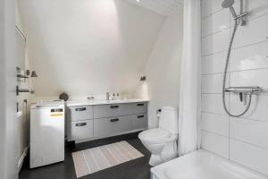 a white bathroom with a toilet and a sink at 890-Hvide-Sande-Bredgade-3-B-1 in Hvide Sande +31 photos