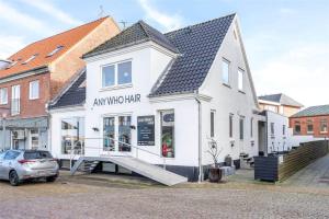 a white building with a window and a car at 890-Hvide-Sande-Bredgade-3-B-1 in Hvide Sande