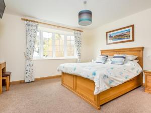 a bedroom with a bed and a window at 3 Bed in Penrith oc-sz299 in Pooley Bridge