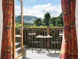 a patio with a table and chairs on a balcony at 3 Bed in Penrith oc-sz299 in Pooley Bridge