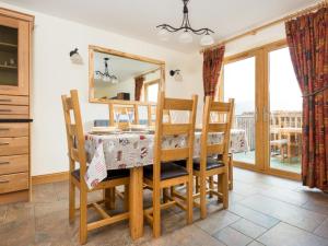 a dining room with a table and chairs and a mirror at 3 Bed in Penrith oc-sz299 in Pooley Bridge