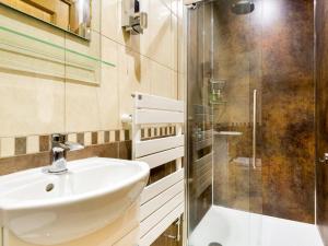a bathroom with a sink and a glass shower at 3 Bed in Penrith oc-sz299 in Pooley Bridge