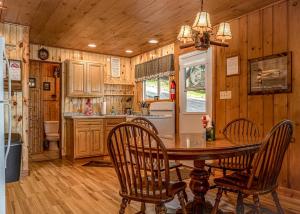 a kitchen with a table and chairs and a refrigerator at Timbers - Bouchard Shores Resort in Minocqua