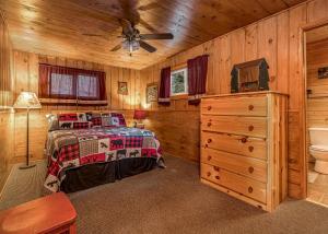a bedroom with a bed and a ceiling fan at Timbers - Bouchard Shores Resort in Minocqua