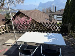 a table and chairs in front of a fence at Lake View near Lucerne in Hergiswil